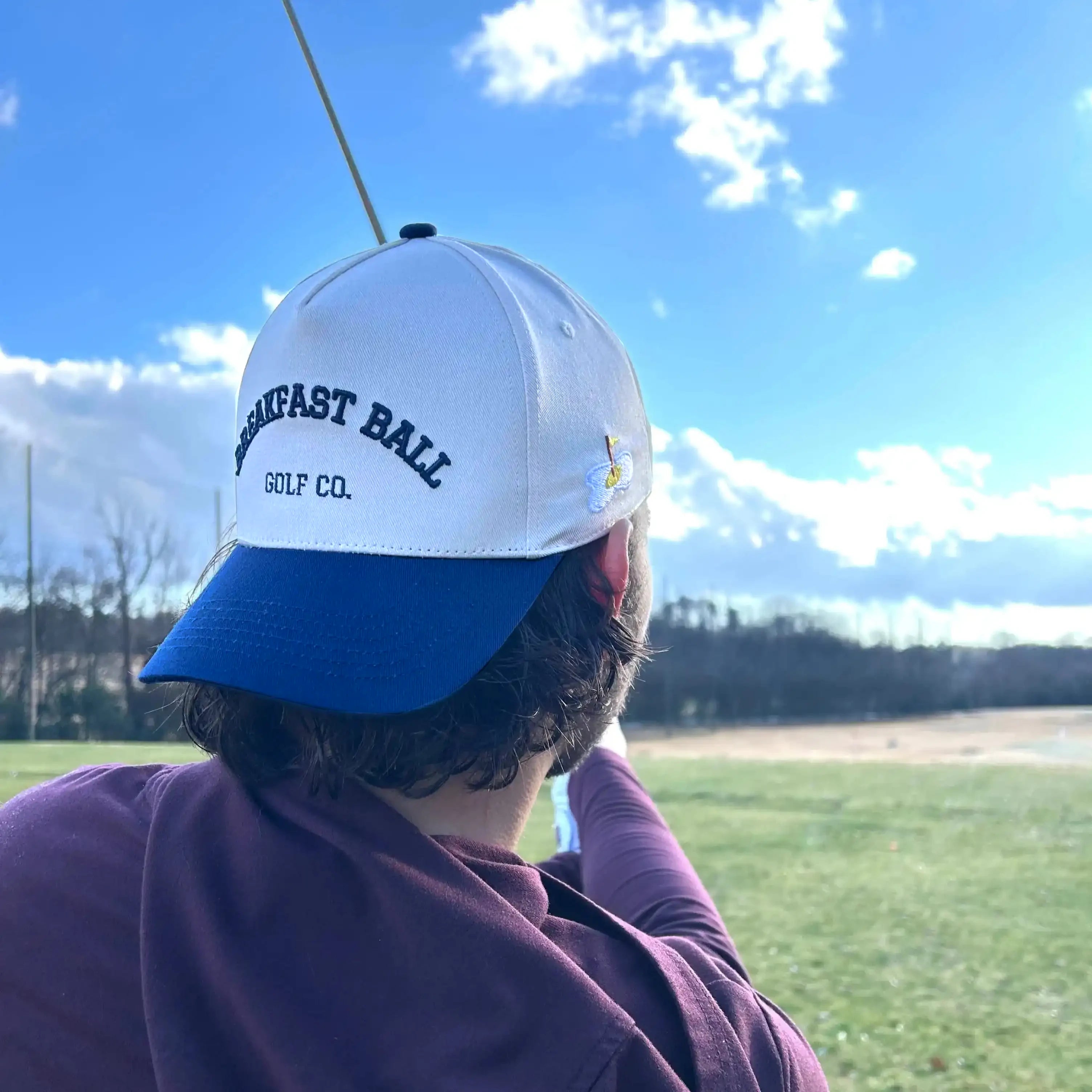 man swinging golf club