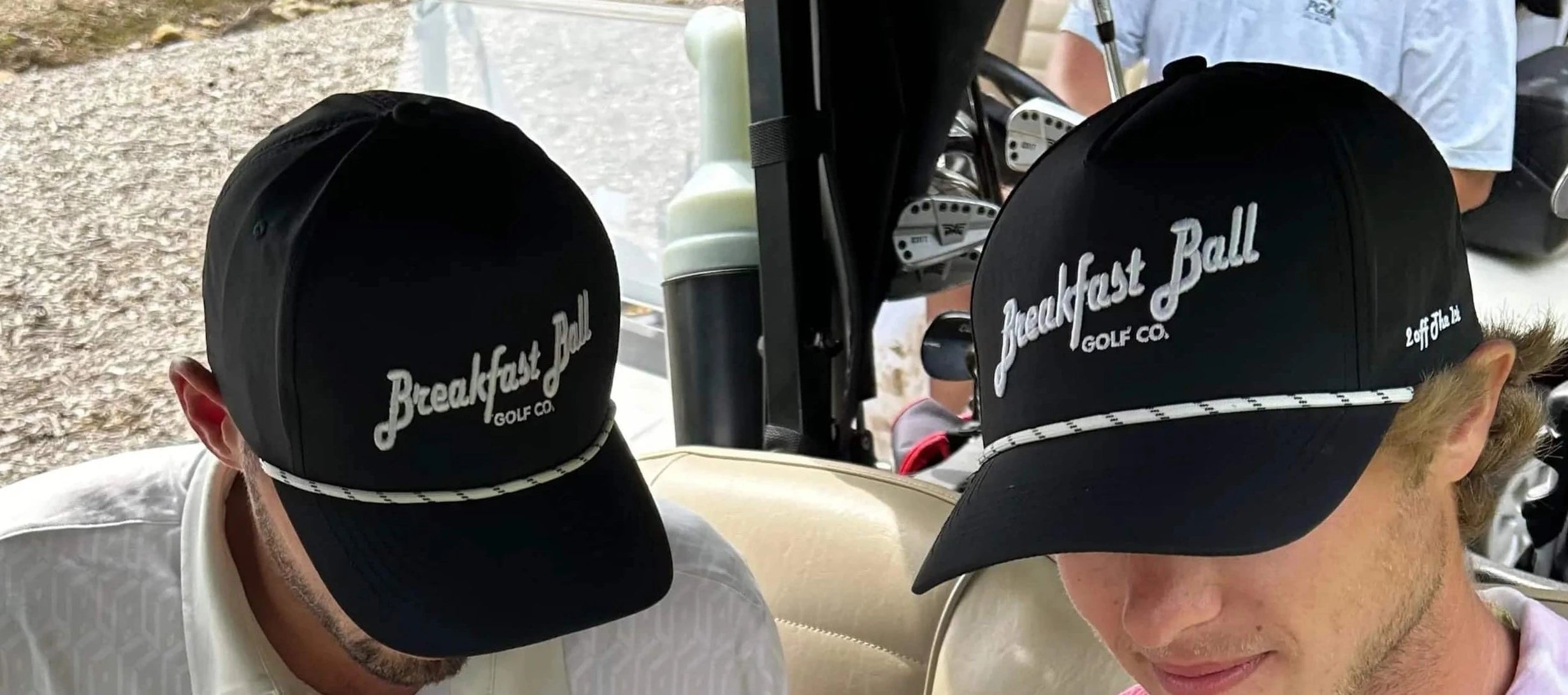Two people wearing black 'Breakfast Ball' caps