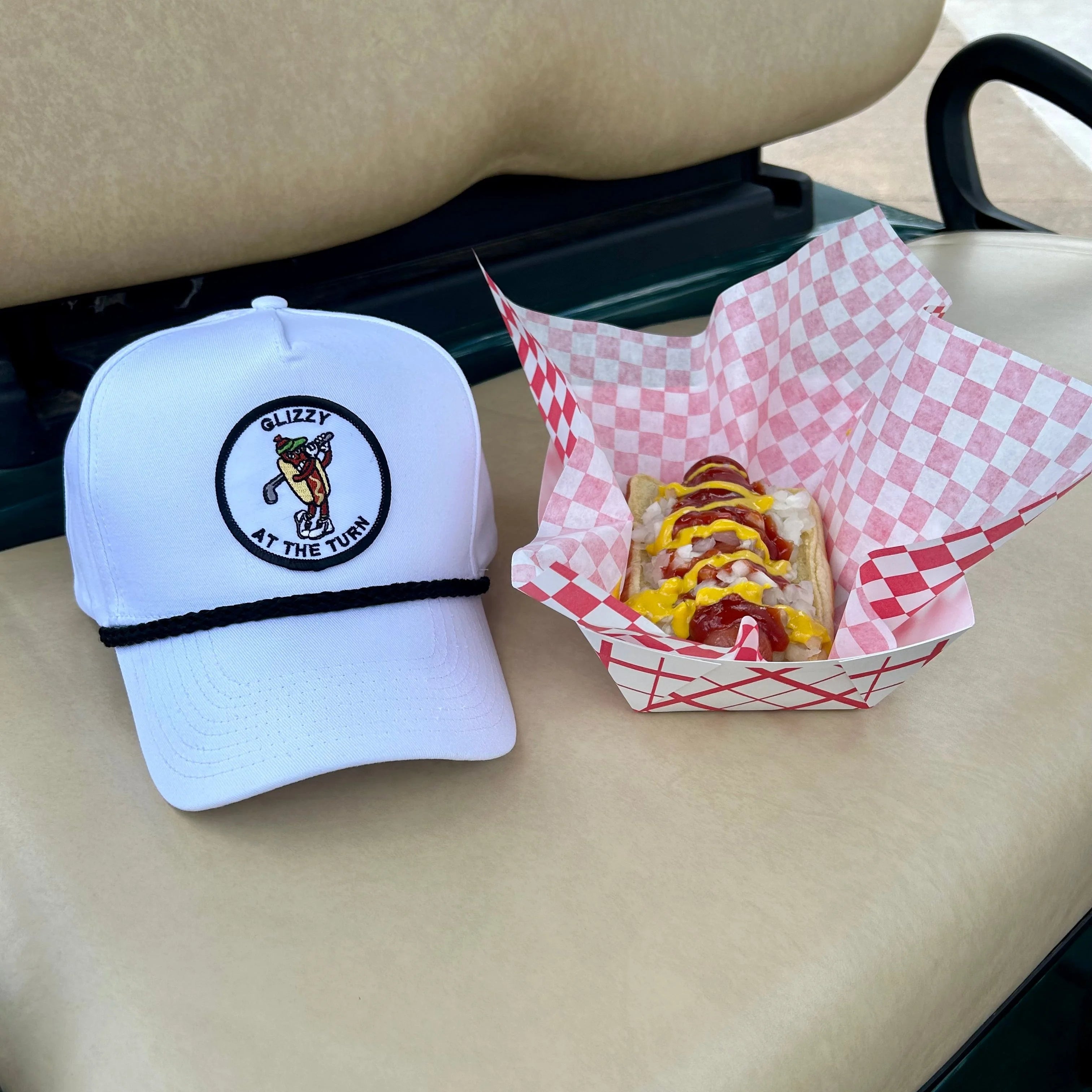 Golf hat next to hot dog